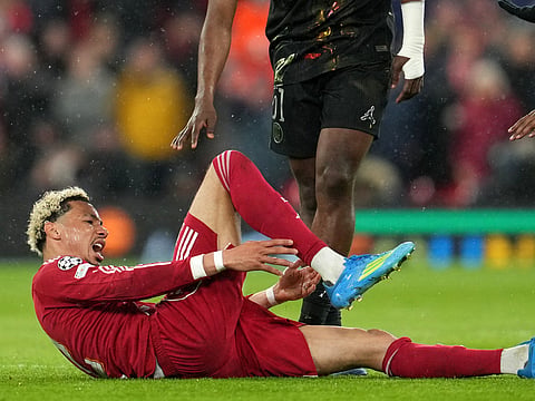 Hugo Ekitike reacts after getting injured during the Champions League quarterfinal second leg soccer match between Liverpool and Paris Saint-Germain in Liverpool, England, Tuesday, April 14, 2026.