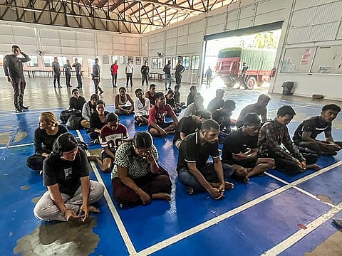 Survivors sitting after being rescued during a search and rescue operation off the coast of Pangkor Island in Perak.