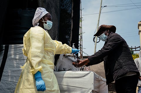 A visitor washes his hands before entering Kyeshero Hospital at a checkpoint for hand washing and temperature screening for all visitors and patients entering Kyeshero Hospital, as part of Ebola prevention measures in Goma on May 18, 2026.