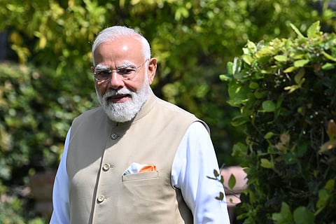 Indian Prime Minister Narendra Modi stands after planting a tree with Italian Prime minister at Villa Doria Pamphili in Rome on May 20, 2026, as the two leaders hold bilateral talks focusing on strengthening India-Italy cooperation.