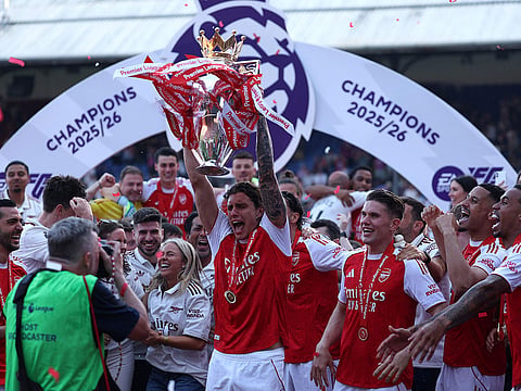 Arsenal's Italian defender #33 Riccardo Calafiori lifts the Premier League trophy at a presentation ceremony on the pitch after the English Premier League football match between Crystal Palace and Arsenal at Selhurst Park in south London.
