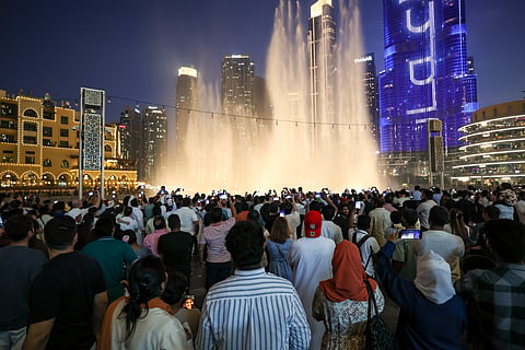 Huge crowd during Eid Al Adha celebrations at Dubai mall fountain area.