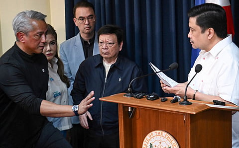 Philippines' Interior Secretary Jonvic Remulla (left) gestures to Philippine Senator Jose "Jinggoy" Estrada (right) after a press conference as Estrada's colleagues, Senators Imee Marcos (2nd L), Senate President Alan Cayetano (C), and Rodante Marcoleta (2nd from right) look on, after a warrant of arrest was served at the Senate building in Manila on June 1, 2026.