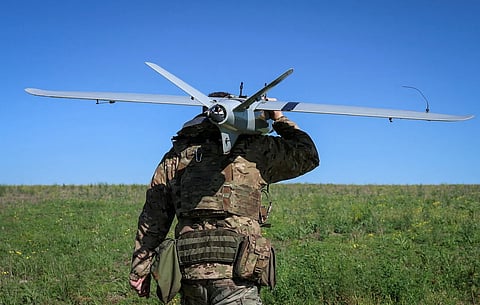 A Ukrainian soldier carries a drone. Cross-border drone attacks have intensified in recent months as Russia and Ukraine continue to trade strikes in the more than four-year war.