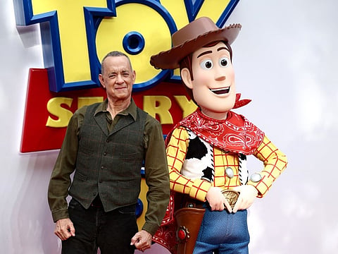 US actor Tom Hanks poses with his character Woody, upon arrival to attend the red carpet for the UK launch event of the film 'Toy Story 5' in London on May 28, 2026.