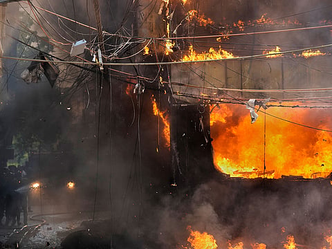 Fire officials douse a fire at a hotel in New Delhi, India