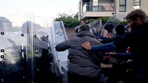 In this image taken from PA Video, police and protestors clash during a protest following the death of Henry Nowak, a 18-year-old student stabbed to death with a Sikh kirpan ceremonial by Vickrum Digwa, in Southampton, England, Tuesday June 2, 2026.