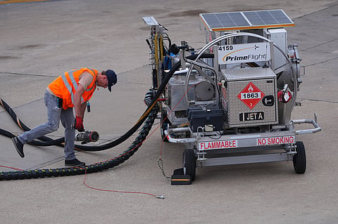 FILE - A worker finishes up fueling a jet at DFW International Airport in Grapevine, Texas, April 14, 2026. (AP Photo/LM Otero, File)
