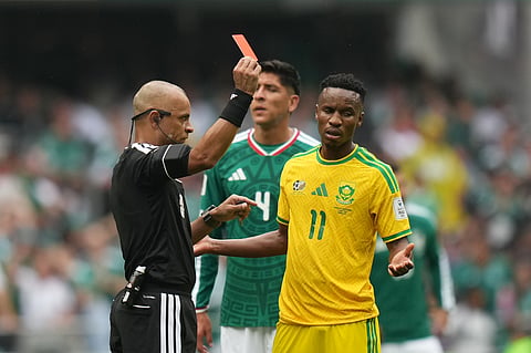 Referee Wilton Sampaio, of Brazil, show the red card to South Africa's Themba Zwane during the World Cup Group A soccer match between Mexico and South Africa in Mexico City, Thursday, June 11, 2026. (AP Photo/Silvia Izquierdo)
