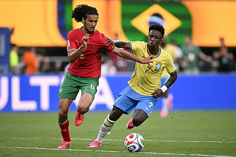 Morocco's midfielder #06 Ayyoub Bouaddi and Brazil's forward #07 Vinicius Junior fight for the ball during the 2026 World Cup Group C football match between Brazil and Morocco at the New York/New Jersey Stadium in East Rutherford on June 13, 2026.