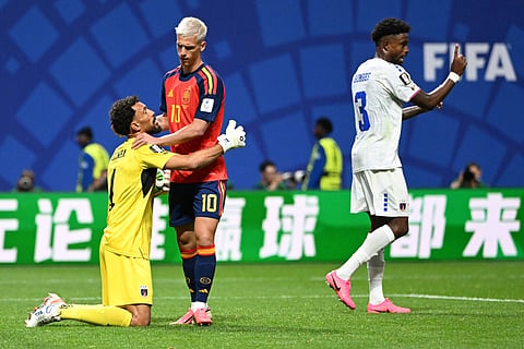 Cape Verde's goalkeeper #01 Vozinha (L) and Spain's forward #10 Dani Olmo (C) apologize after a contact during the 2026 World Cup Group H football match between Spain and Cape Verde at the Atlanta Stadium in Atlanta on June 15, 2026.