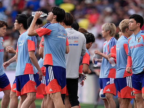 A Japan national team player takes a drink of water during a training session in Nashville, Tenn., ahead of the World Cup soccer tournament.