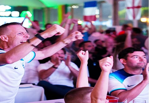 Football fans celebrate at the Ranches Restaurant by the Golf Course.