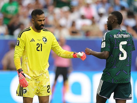 Mohammed Al-Owais and Hassan Al-Tambakti of Saudi Arabia fist bump during the FIFA World Cup 2026 Group H match between Saudi Arabia and Uruguay at Miami Stadium