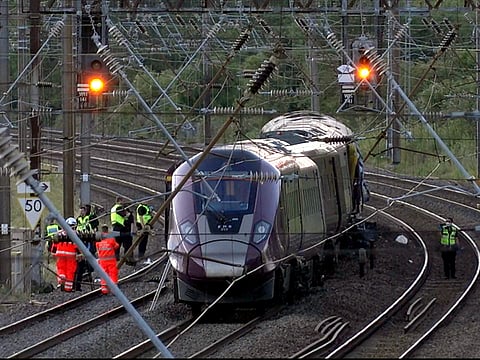 Emergency personnel work on a train on the tracks outside Bedford, England, after a train from Corby to London St. Pancras and another from Nottingham to London St. Pancras, collided.