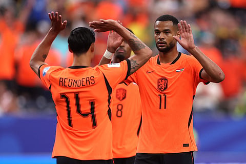 Cody Gakpo #11 of the Netherlands celebrates with teammate Tijjani Reijnders #14 after scoring his team's fourth goal during the FIFA World Cup 2026 Group F match between Netherlands and Sweden at Houston Stadium on June 20, 2026 in Houston, Texas.