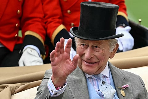 Britain's King Charles III waves as he arrives on the second day of the Royal Ascot horse racing meeting in Ascot, west of London, on June 17, 2026.