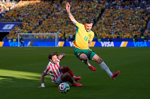 Australia's Aiden O'Neill (13) battles for the ball with Paraguay's Matias Galarza (23) during the World Cup Group D match in Santa Clara, California, on Thursday, June 25, 2026.