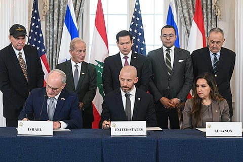 US Secretary of State Marco Rubio (C, back) looks on as (L/R, front row) Israeli Ambassador to the US Yechiel Leiter, State Department Chief of Staff Daniel Holler, and Lebanese Ambassador to the US Nada Hamadeh sign a framework agreement at the US Department of State in Washington, DC, on June 26, 2026.