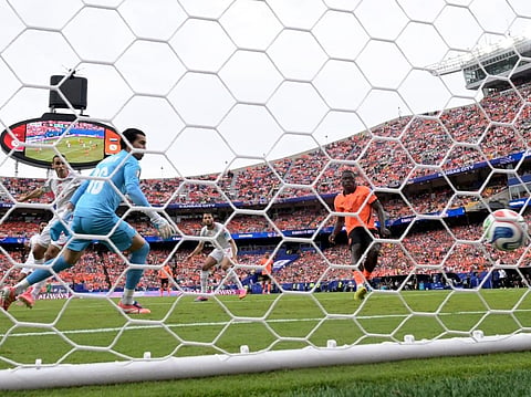 Netherlands' forward #19 Brian Brobbey (R) scores his team's second goal during the 2026 World Cup Group F football match against Tunisia at the Kansas City Stadium in Kansas City on June 25, 2026.