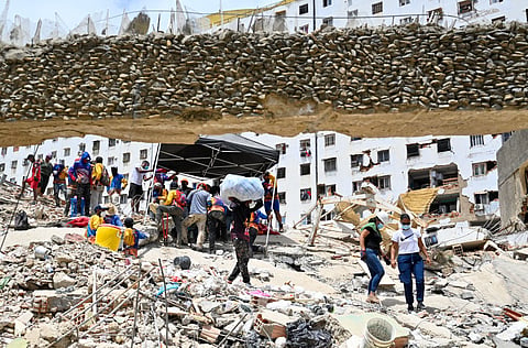 Volunteers work at the site of a collapsed building following earthquakes in Caraballeda, La Guaira state, Venezuela, on June 26, 2026.