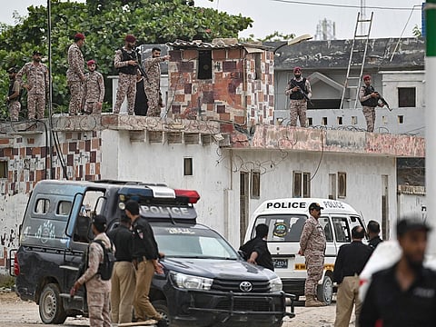 Security personnel inspect the rooftop of a compound at the end of a clearance operation following an alleged explosion and a militant attack in Karachi on June 28, 2026.