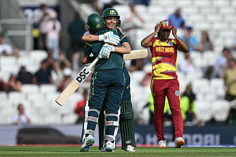 Australia's Beth Mooney (L) and Australia's Ashleigh Gardner (C-facing) embrace as they celebrate the team's victory in the ICC Women's T20 cricket world cup 2026 semi-final game between Australia and West Indies, at The Oval in London on June 30, 2026.