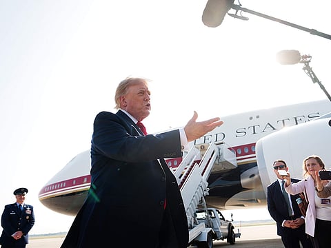President Donald Trump speaks with reporters before boarding the new Air Force One.