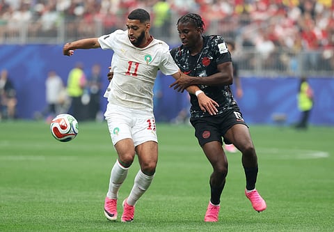 Morocco's midfielder #11 Ismael Saibari and Canada's defender #15 Moise Bombito fight for the ball during the 2026 World Cup round of 16 football match between Canada and Morocco at the Houston Stadium in Houston on July 4, 2026.