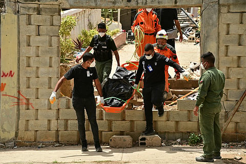 Rescue workers carry a corpse recovered from the rubble in Playa Grande, Catia La Mar, La Guaira State, Venezuela on July 5, 2026, following the June 24 twin earthquakes.