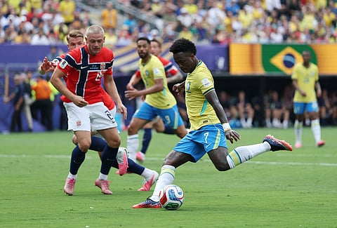 Vinícius Júnior #7 of Brazil shoots against Julian Ryerson #26 of Norway during the FIFA World Cup 2026 Round Of 16 match between Brazil and Norway at New York New Jersey Stadium on July 05, 2026 in East Rutherford, New Jersey.