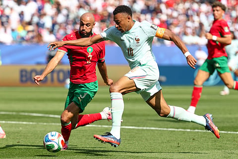 France's forward #10 Kylian Mbappe runs with the ball before being fouled by Morocco's defender #03 Noussair Mazraoui to concede a penalty during the 2026 World Cup football tournament quarter-final match between France and Morocco at Boston Stadium in Foxborough on July 9, 2026.