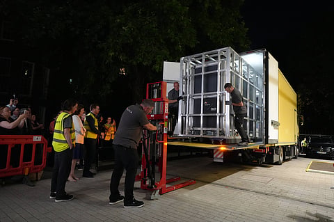Workers unload a box that contains the Bayeux Tapestry out of a truck at the British Museum in London, Friday, July 10, 2026.