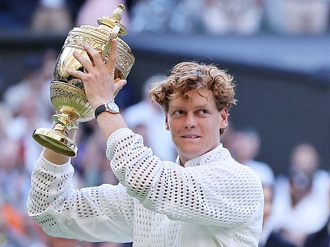 Italy's Jannik Sinner poses with the Gentleman's Singles trophy after his victory against Germany's Alexander Zverev at the end of their men's singles final of the 2026 Wimbledon Championships at The All England Lawn Tennis and Croquet Club in Wimbledon, southwest London, on July 12, 2026.