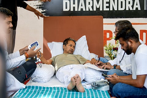 Environmentalist Sonam Wangchuk being attended by medical professionals on the 18th day of his indefinite hunger strike during a protest by the Cockroach Janata Party (CJP), demanding the resignation of Union Education Minister Dharmendra Pradhan.