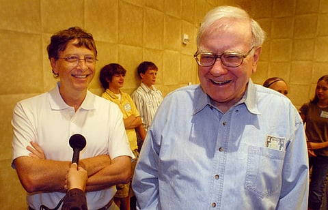 FILE - Microsoft co-founder and chairman Bill Gates, left, and Berkshire Hathaway Inc. billionaire Warren Buffett laugh while answering questions Aug 5, 2006, before the Nebraska Regional Bridge tournament in Council Bluffs, Iowa.