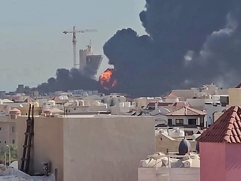 A plume of black smoke and flames billowing over the town of Mangaf, south of Kuwait City. Kuwait accused Iran of targeting civilian sites and vital infrastructure in the country, after reporting attacks on an oil facility and a power and water plant.