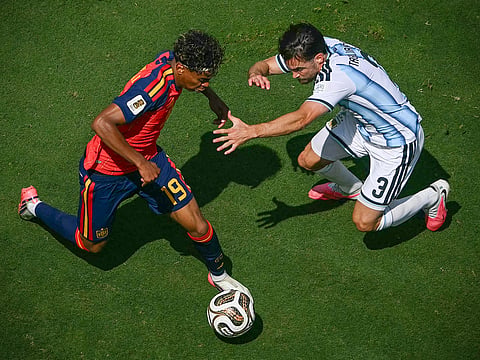 Spain's forward Lamine Yamal and Spain's defender Alex Grimaldo fight for the ball during the 2026 World Cup football final at the New York/New Jersey Stadium in East Rutherford on July 19, 2026.