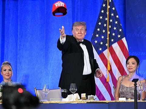 US President Donald Trump throws his 'Trump 2028' hat during the 2026 White House Correspondents' Association (WHCA) Dinner at the Waldorf Astoria in Washington, DC, on July 24, 2026.