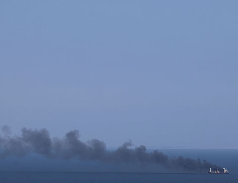 Smoke rises from a civilian ship in the Black Sea off Odesa. Attacks on commercial vessels in the region have increased since April 2026.