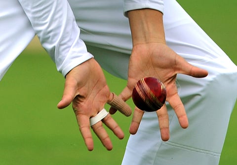 FILE - View of cricketer's hands catching a cricket ball during day four of the first Ashes Test cricket match, in Cardiff, Wales, Saturday, July 11, 2015. (AP Photo/Rui Vieira, file)