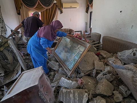 Mahasen Faqih and her husband, Mohammed Sobeih, inspect their home, destroyed during the Israeli military operation, after returning to it in Zawtar Al Gharbieh, Lebanon, Tuesday, July 28, 2026.