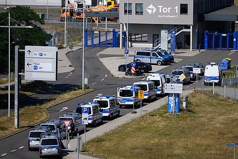 Police vehicles are parked at Leipzig/Halle Airport, where investigations are underway following the drone incident that occurred early Wednesday morning, in Schkeuditz, Germany, on Thursday Aug. 6, 2026.