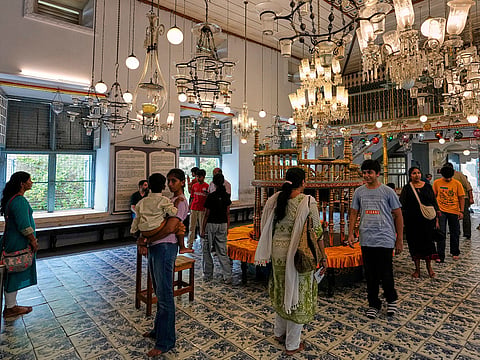 Tourists visit the main hall adorned with 19th-century Belgian crystal chandeliers and colourful glass lanterns at the 458-year-old Paradesi Synagogue in the historic Jew Town neighbourhood of Kochi, India, Wednesday, May 20, 2026.