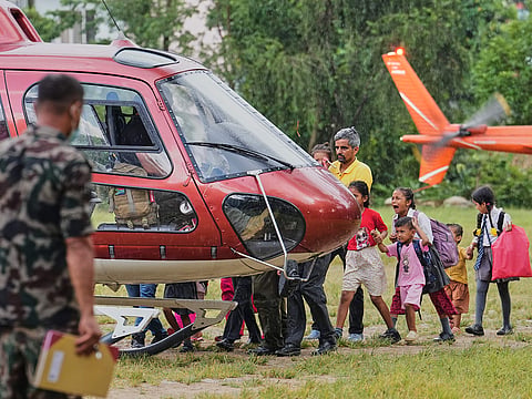 A girl cries as she boards a helicopter with her family after being rescued from their village, which was cur off by flash flooding in Nepal's Nuwakot district, on Friday, Aug. 28, 2026.