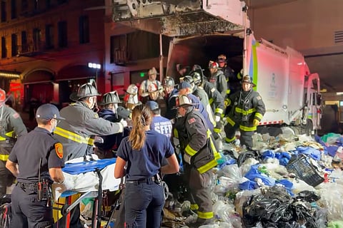 A passer-by heard cries for help after the truck had already compacted its first load.
