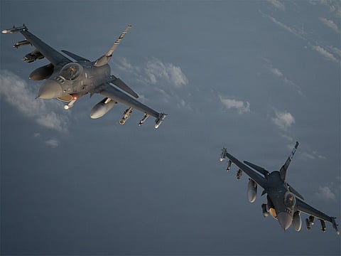 Two US Air Force F-16 fighter jets patrol the skies over the Middle East.