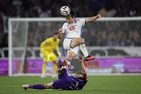 Lille's Japenese forward #18 Ayase Ueda (top) heads the ball during the French L1 football match between Toulouse Football Club (TFC) and Lille LOSC at the Stadium in Toulouse, southwestern France, on September 3, 2026.
