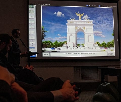 An image of President Donald Trump's proposed triumphal arch to commemorate the country's 250th anniversary is displayed during a public meeting of the Commission of Fine Arts at the National Building Museum on April 16, 2026 in Washington, DC. The Commission of Fine Arts voted unanimously to move forward with a proposed 250-foot arch informally dubbed the "Arc de Trump" that would sit in a roundabout near Memorial Bridge on the Arlington, Virginia side of the Potomac River between Arlington Cemetery and the Lincoln Memorial.