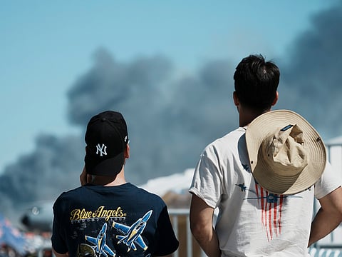 Spectators watch as smoke rises after a Hellenic Air Force F-4 Phantom fighter jet crashed, during the Athens Flying Week airshow at Tanagra Air Force Base, north of Athens, Greece, Saturday, Sept. 5, 2026. Photo/Kallista Allaway)